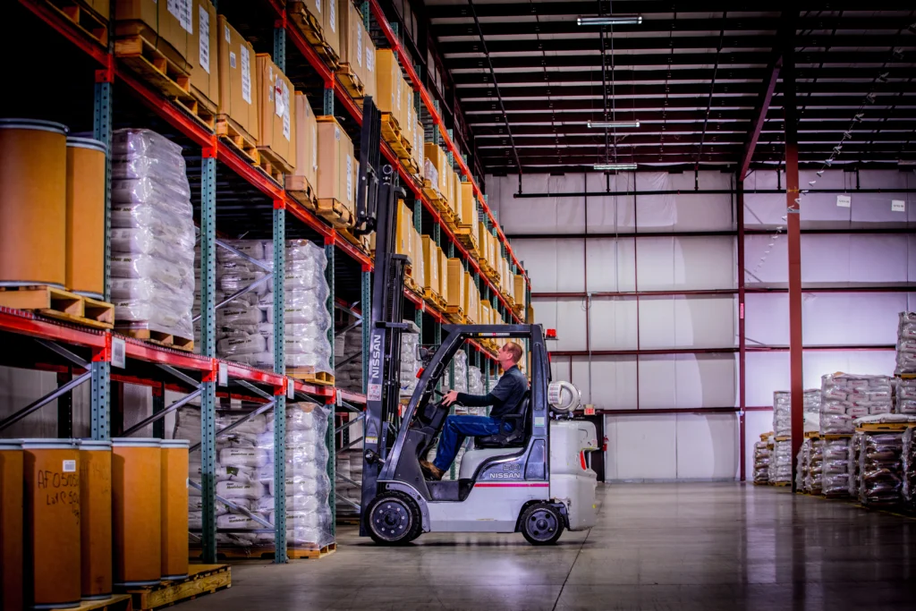 Forklift operator working inside a 3PL warehouse in Indiana, representing efficient distribution and logistics operations